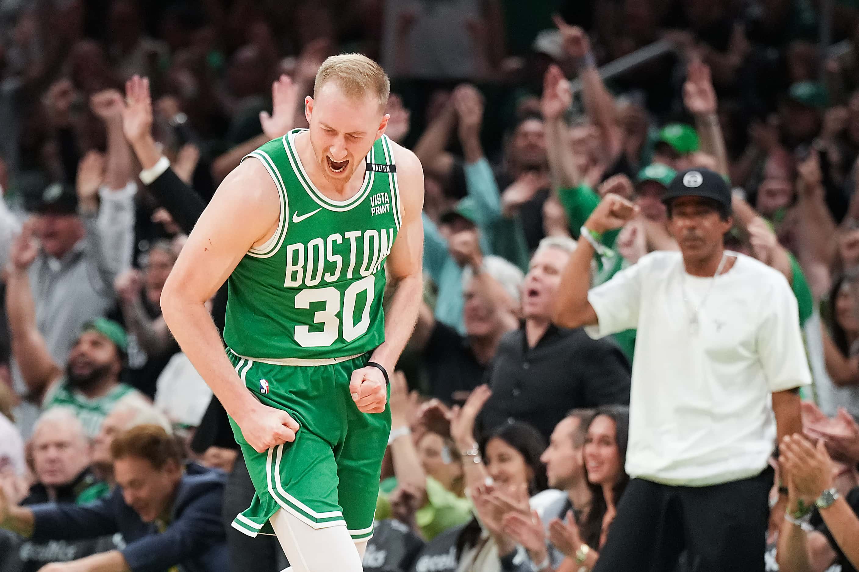Boston Celtics forward Sam Hauser (30) celebrates after hitting a 3-pointer during the first...