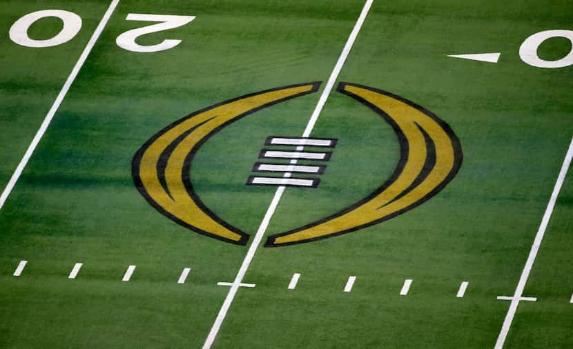 FILE - The College Football Playoff logo is shown on the field at AT&T Stadium before the...