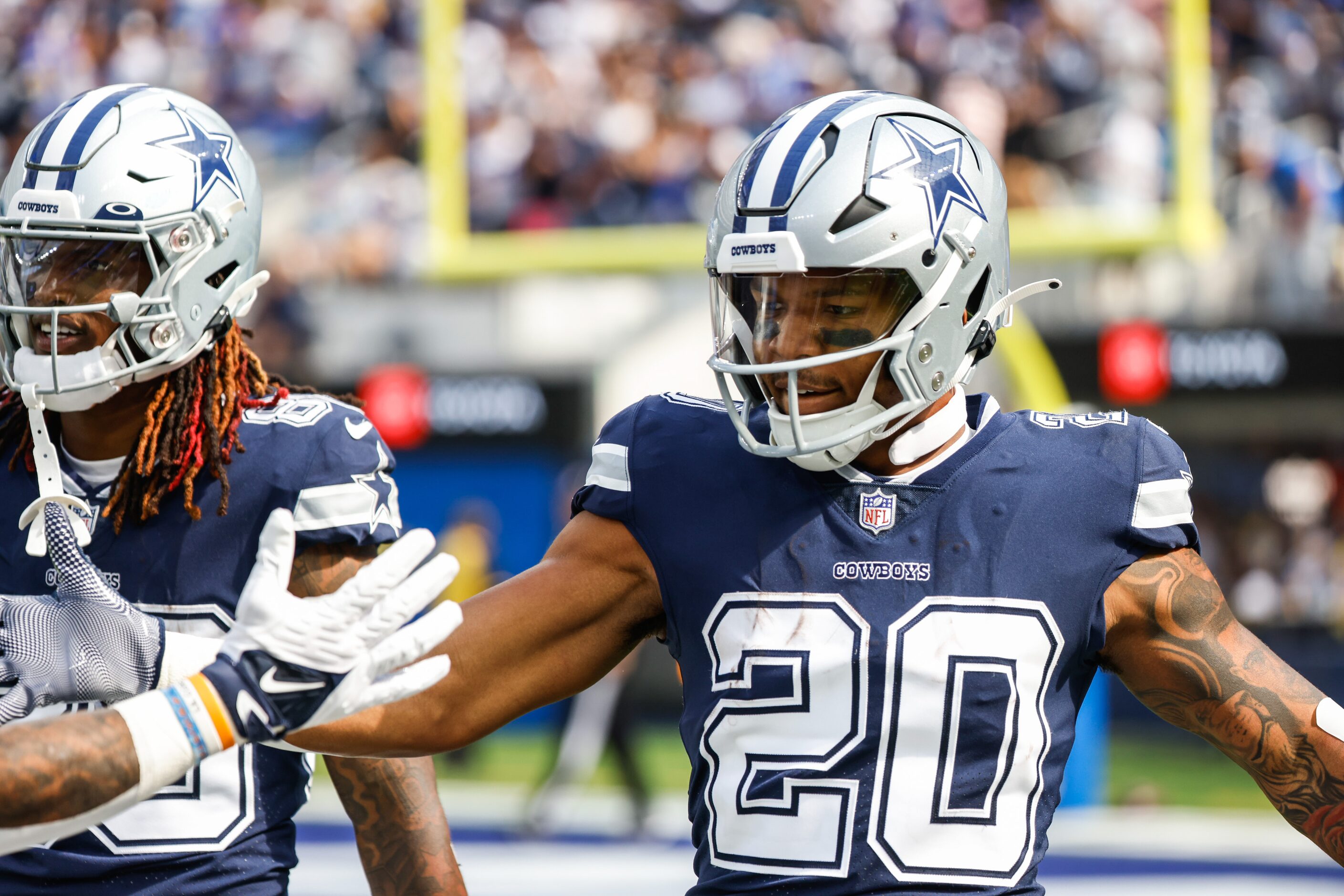 Dallas Cowboys running back Tony Pollard (20) celebrates a touchdown with his teammates...