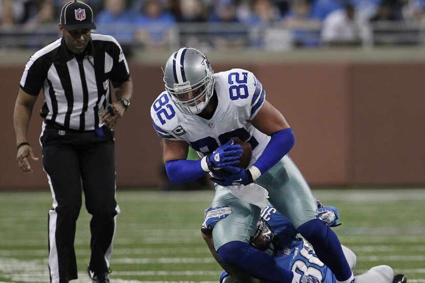 Dallas Cowboys tight end Jason Witten (82) is tackled by Detroit Lions cornerback Darius...