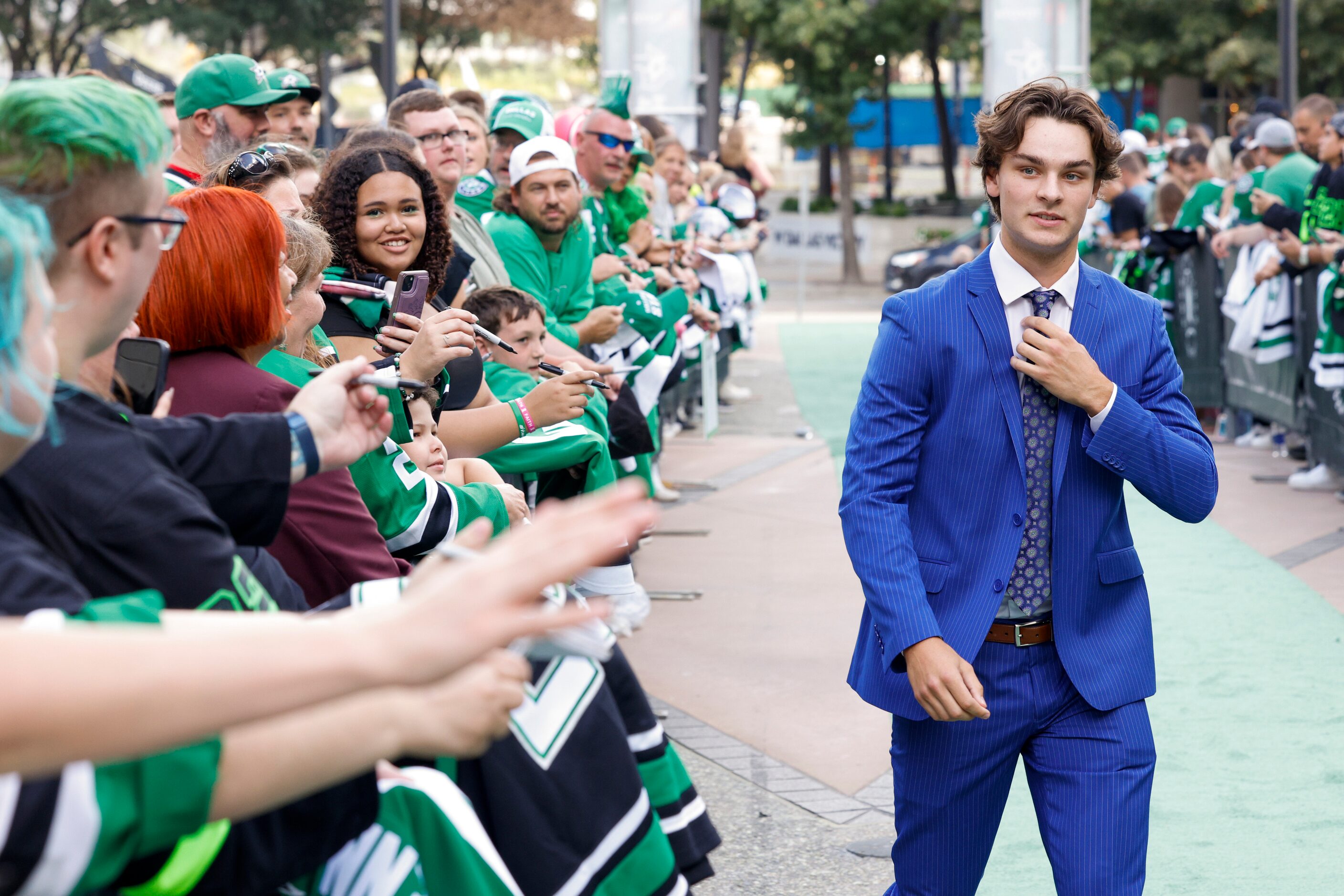 Dallas Stars center Wyatt Johnston walks past fans on the green carpet to the American...