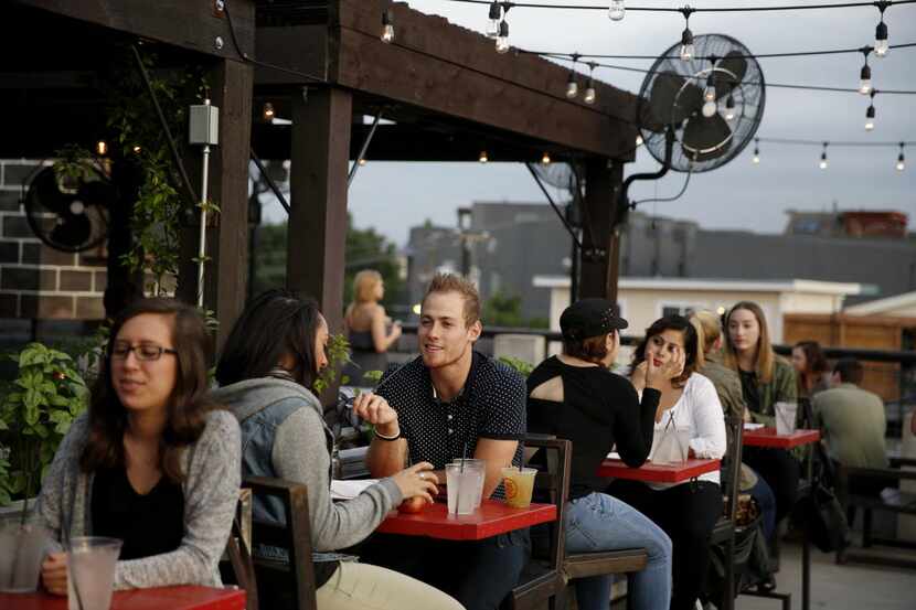 The  patio at HG Sply Co. lets you watch all the action at neighboring establishments from...