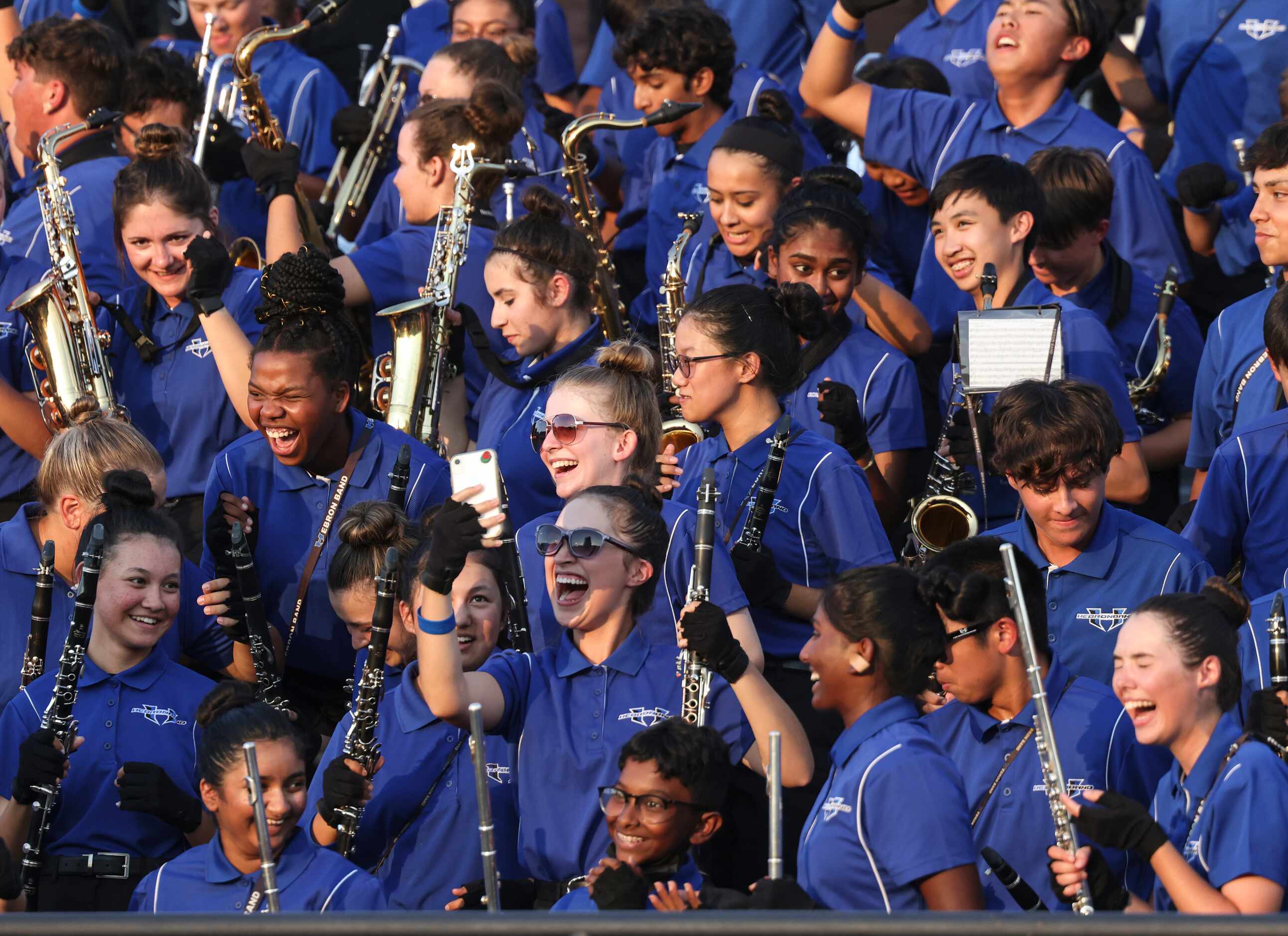 Hebron High School band members cheer in the stands during the football game between Jesuit...