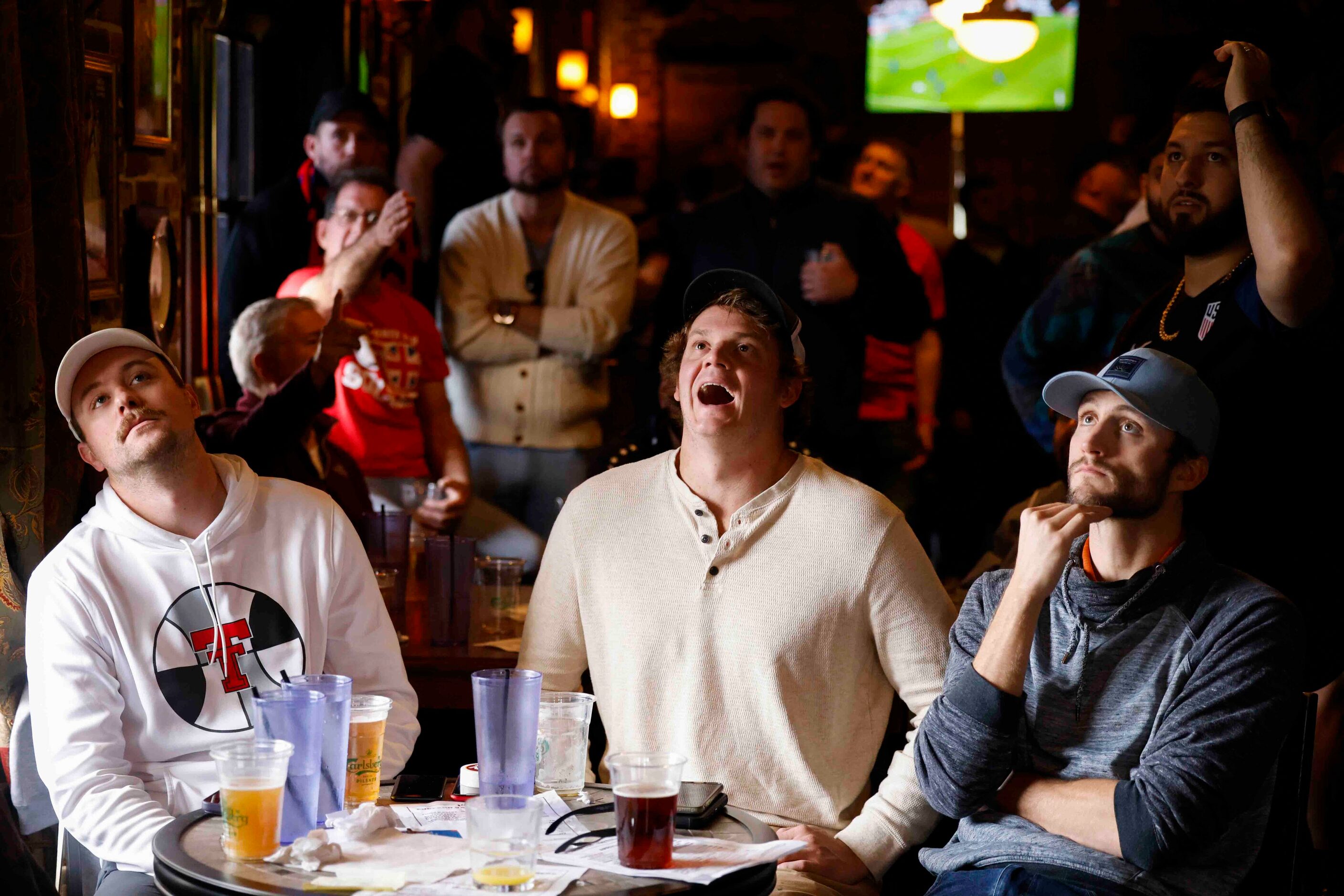 From left, Blake Baker, Charles Foose and and Trevis barber, react towards a soccer game...