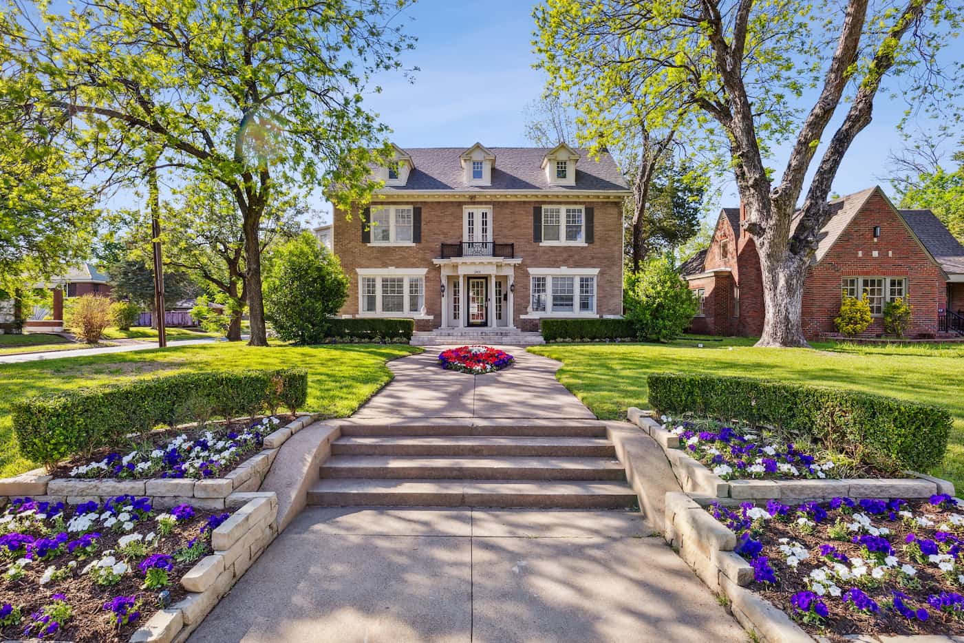 Fresh flowers and a spacious front yard greet guests at the historic home at 2401 South...