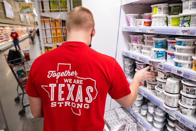 Tyler Land restocks the dairy section at the H-E-B in Hudson Oaks.  