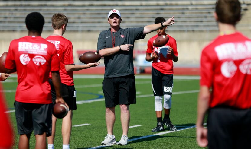 Quarterbacks listen to University of Houston offensive coordinator and former Texas Longhorn...