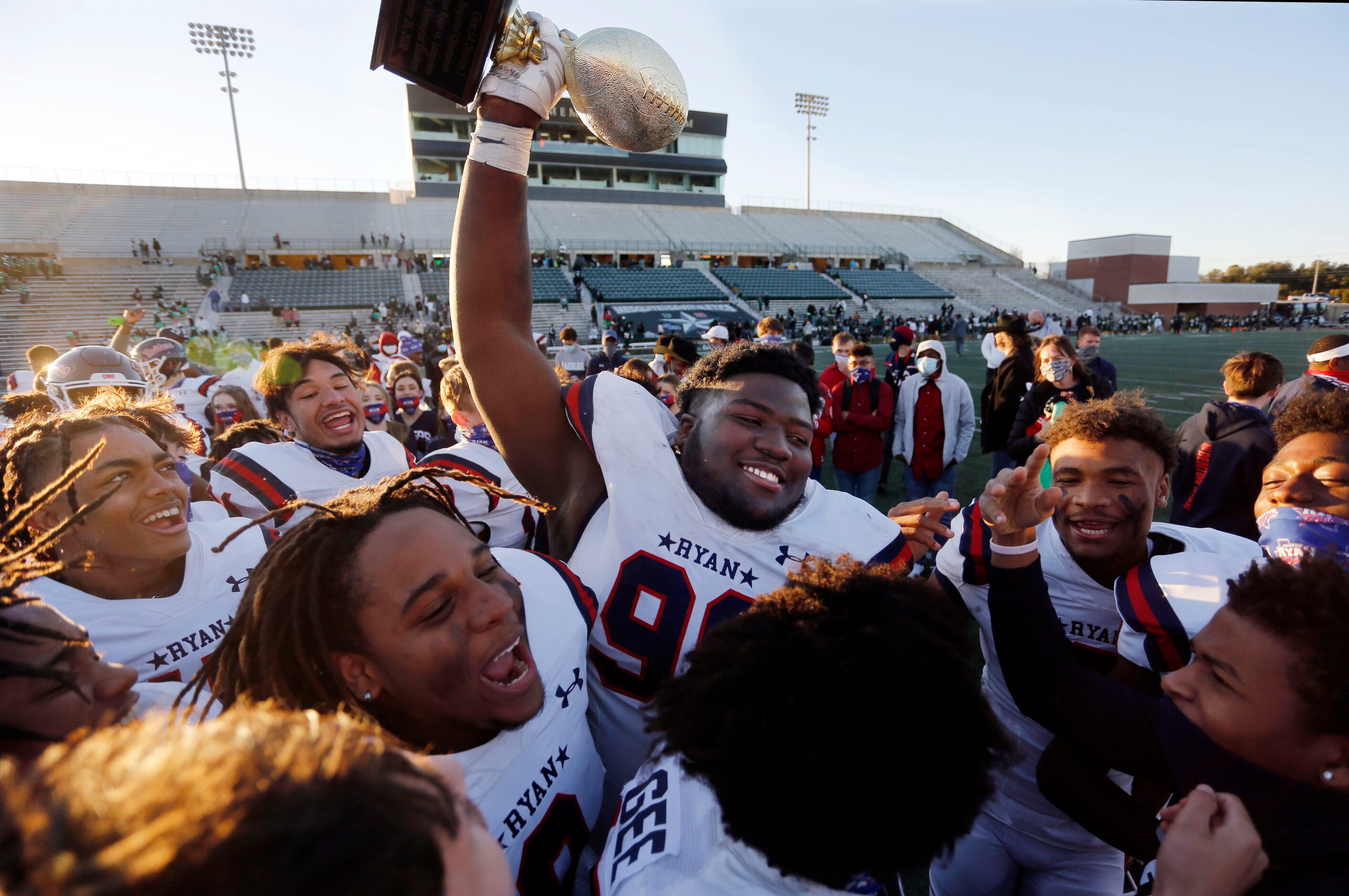 Denton Ryan’s Bear Alexander (96) holds the Class 5A Division I Region I semifinal football...