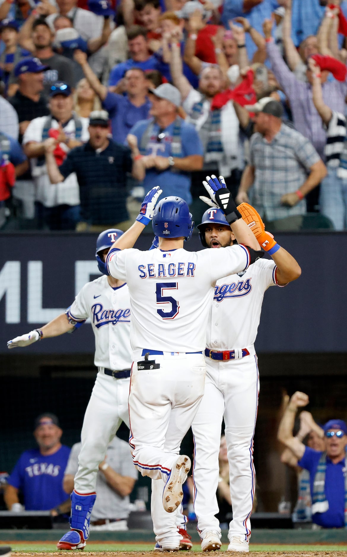 Texas Rangers Corey Seager is congratulated by teammate Leody Taveras after his game-tying...