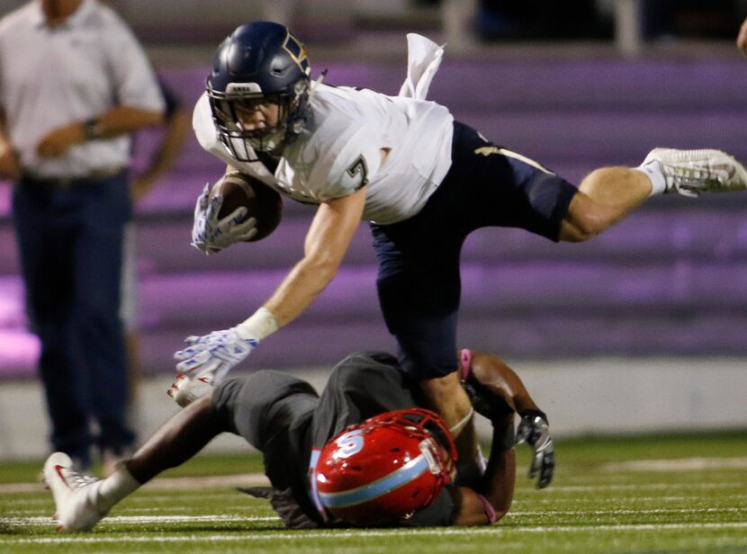 Jesuit receiver Fletcher Rosenbleeth (7) stretches for extra yardage as Dallas Skyline...