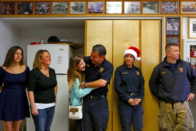 Dallas Fire-Rescue Lt. Ladd Smith hugged his daughter, Claire, as they waited for Christmas...