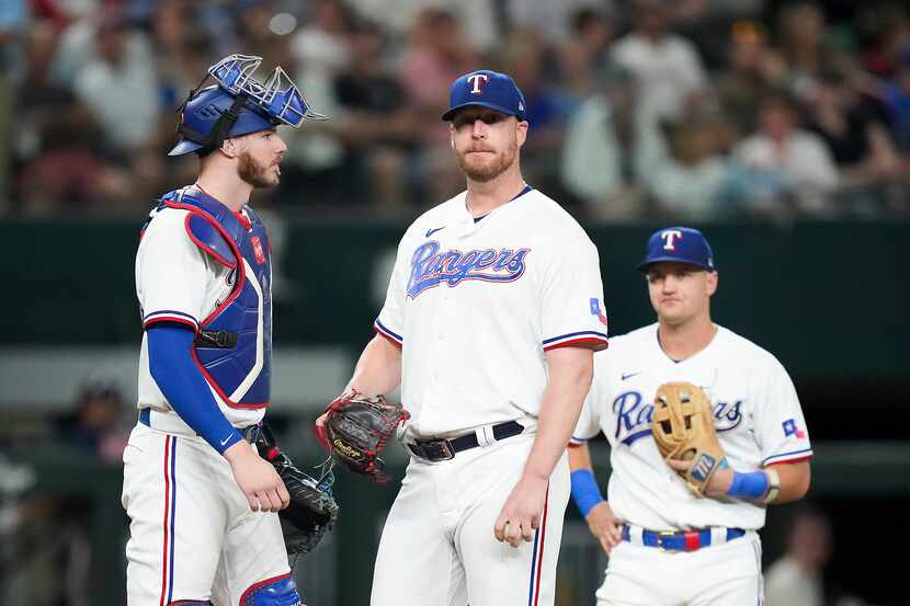 Texas Rangers relief pitcher Will Smith (51) waits to be pulled from the game after giving...