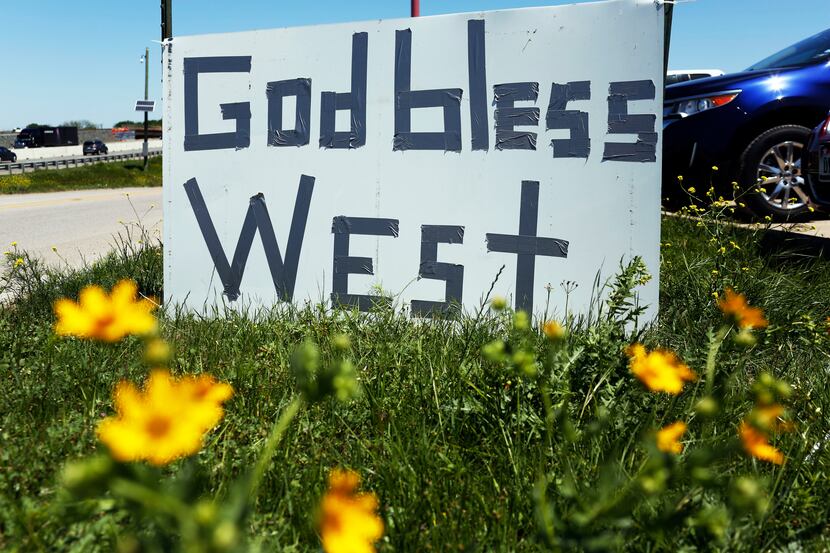 A sign that reads "God Bless West" sits on the side of Interstate 35 in West, Texas, where a...