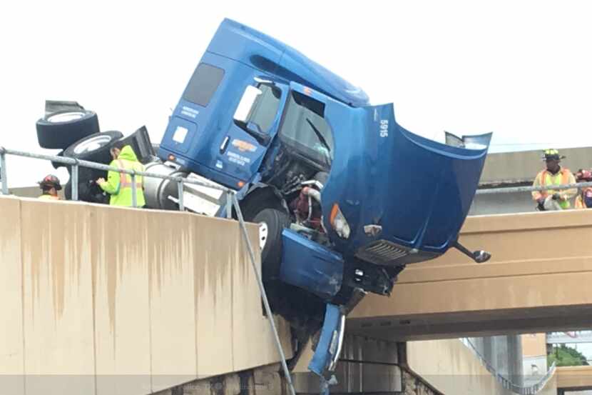 A tractor-trailer crashed in Arlington, and the semi was left dangling over Abram Street.