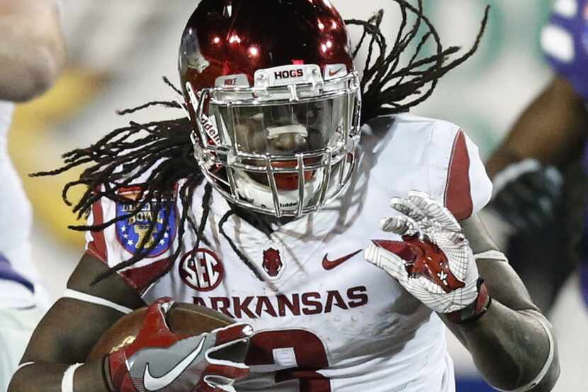 Arkansas running back Alex Collins (3), the game's MVP, takes off on a long run against...