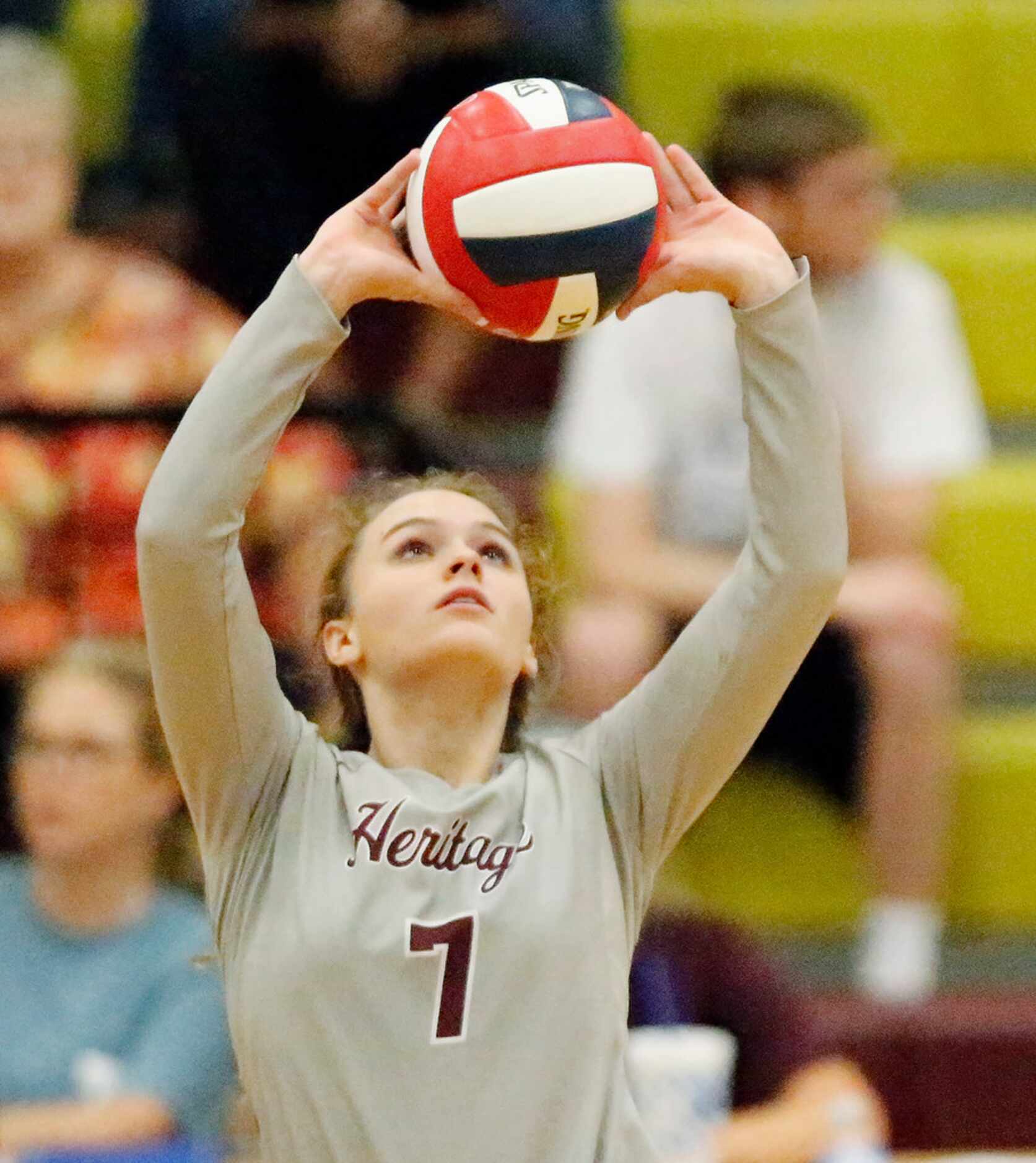 Heritage High School setter Mackenzie Dorsey (7) makes  a set during game one as Heritage...