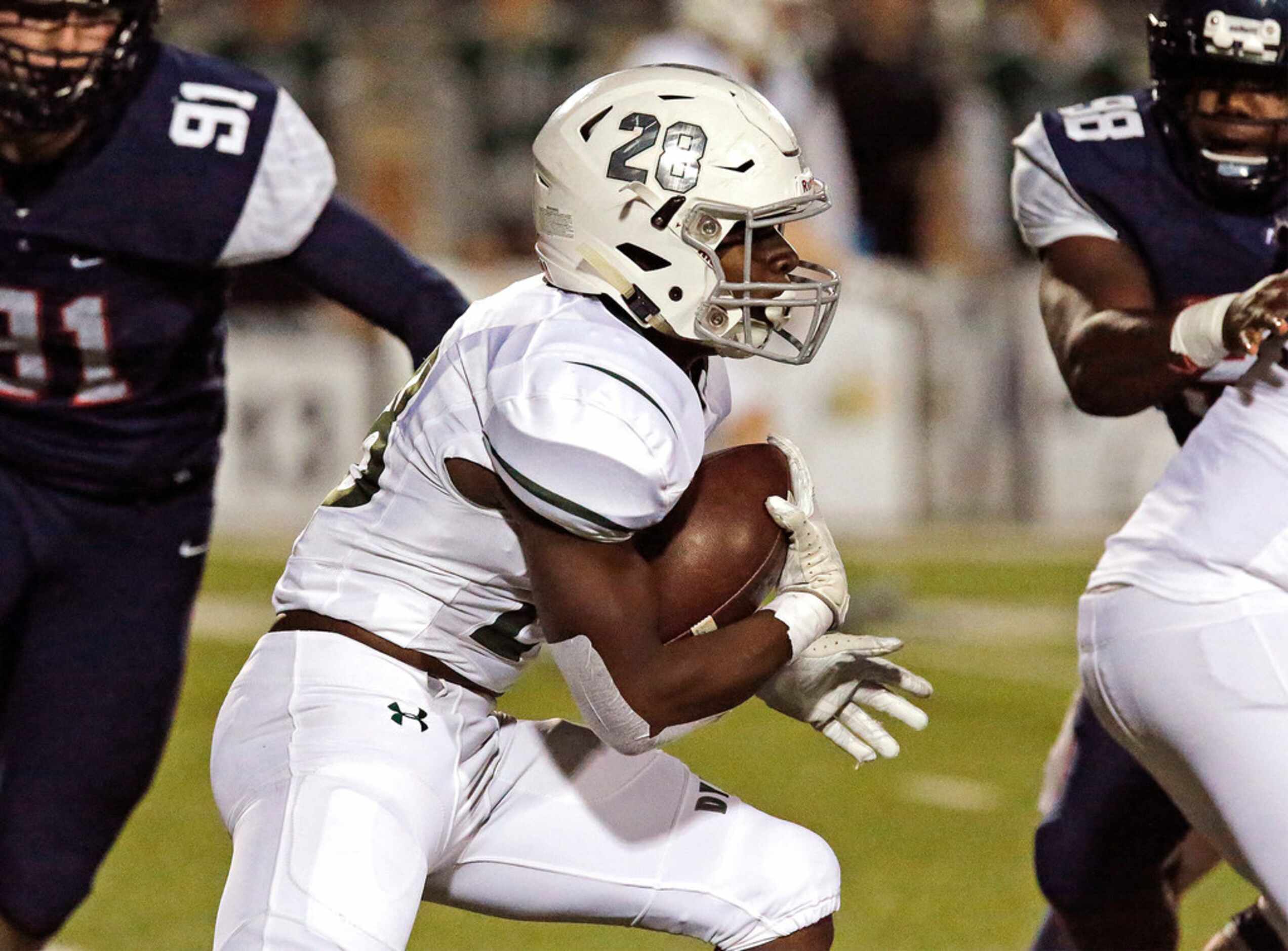 Prosper High School running back J.T. Lane (28) carries the ball during the first half as...