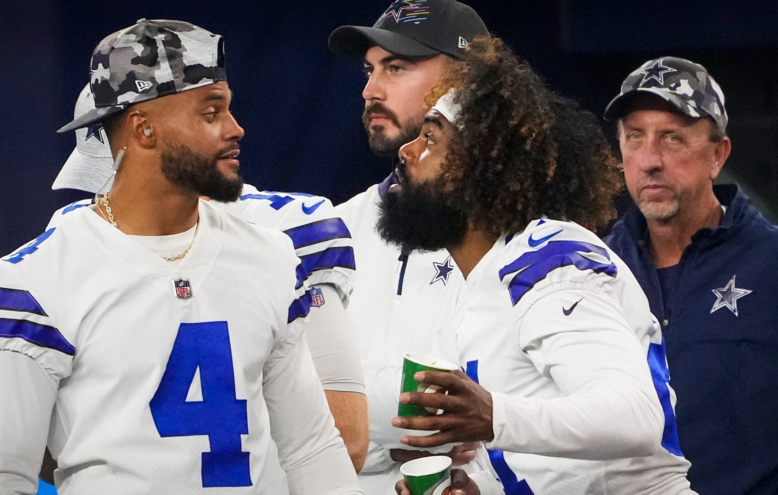 Dallas Cowboys quarterback Dak Prescott (4) laughs on the sidelines with running back...