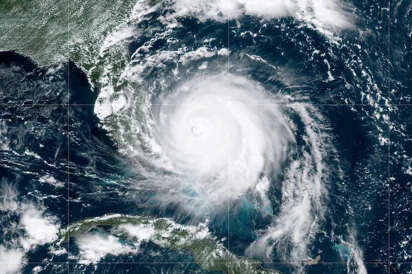 In this NOAA GOES-East satellite image, Hurricane Dorian, now a Category 4 storm, moves...