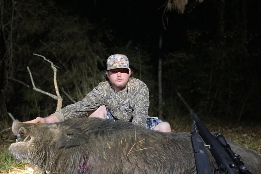 Brenden Bennett of Lewisville with the big boar feral hog that he shot on his grandparent s...