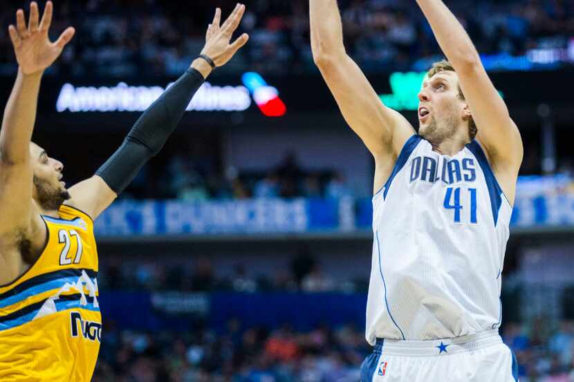 Dallas Mavericks forward Dirk Nowitzki (41) takes a shot over Denver Nuggets guard Jamal...