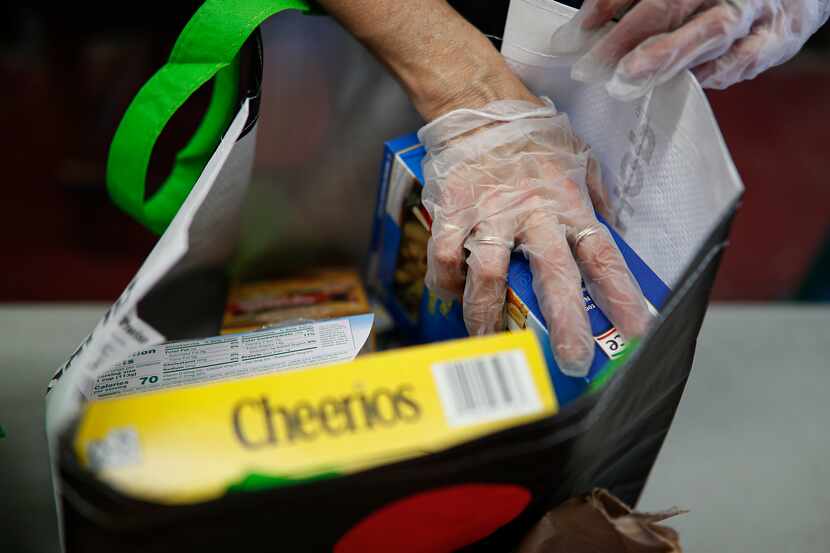 Volunteers packed free groceries for distribution to the elderly at Hope Community Services...