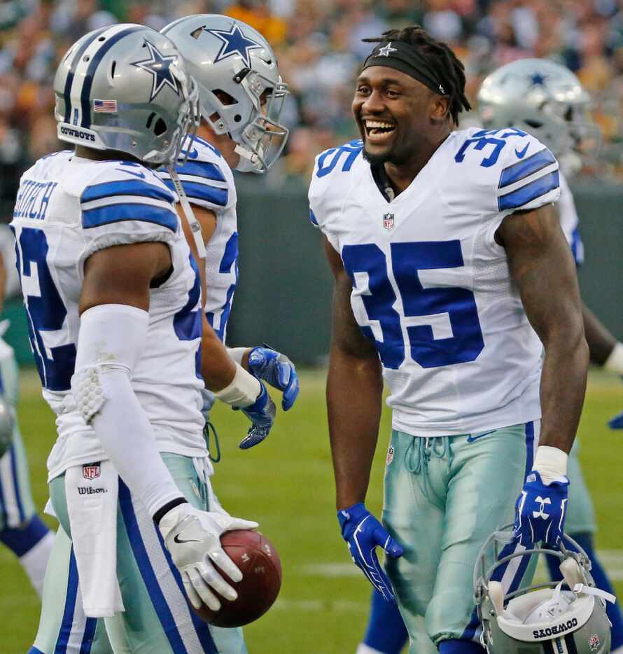 Dallas Cowboys strong safety Kavon Frazier (35) greets teammate Barry Church after his...