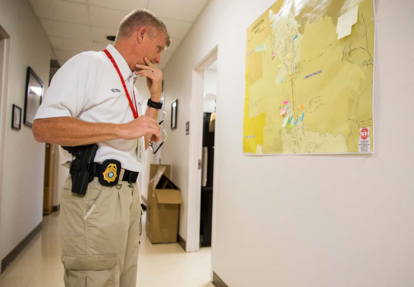 Fire Chief Jeff McNeal looks at a map of the area surrounding Lumberton, Texas as Hurricane...