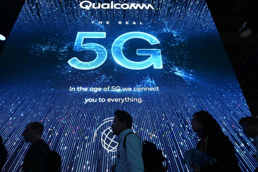Attendees wait in line for a 5G exhibition at the Qualcomm booth during CES 2019 consumer...