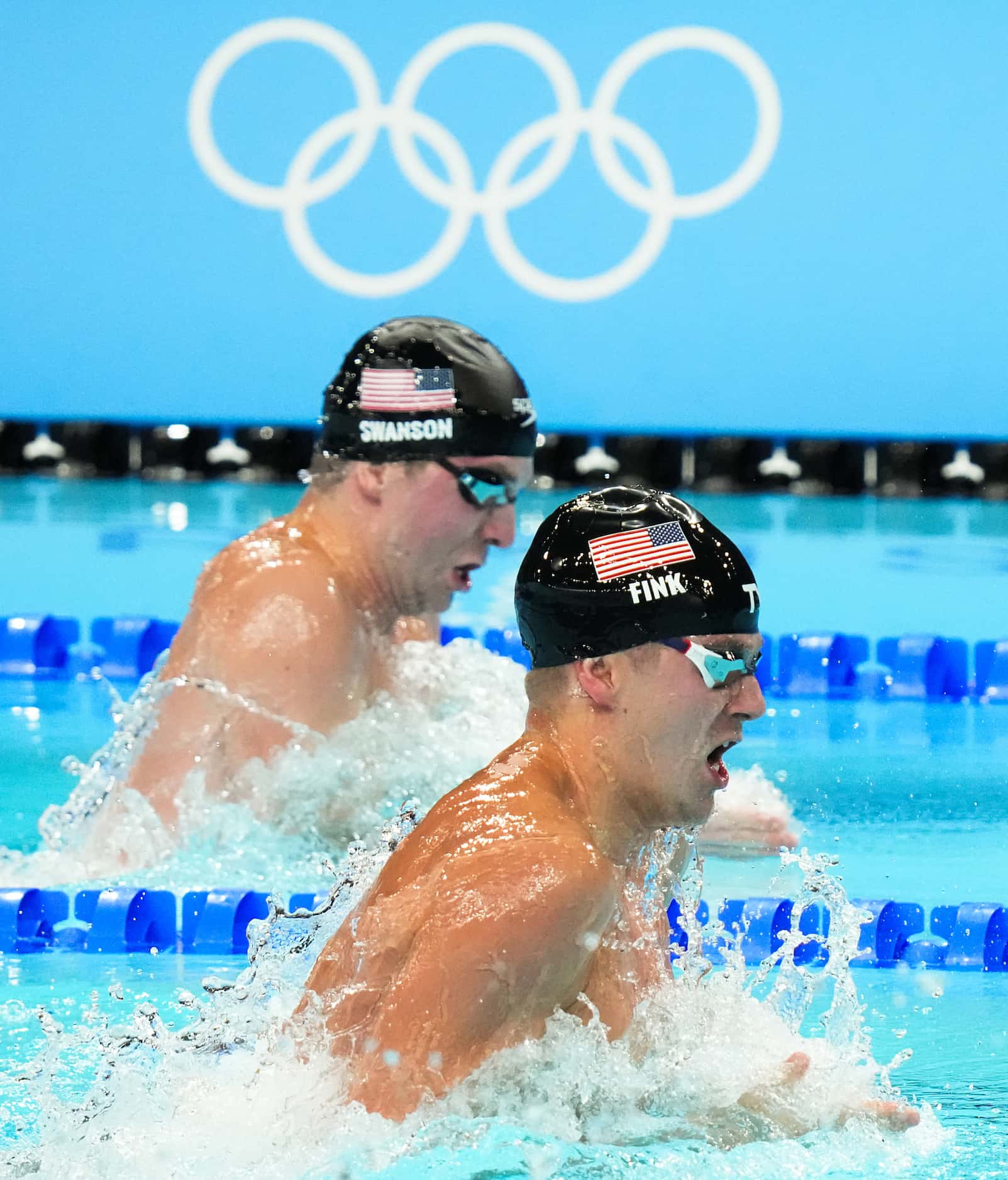Nic Fink (front) and Charlie Swanson of the United States swim in a men's 100-meter...