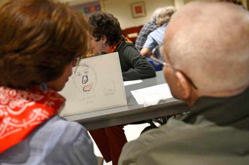 
Volunteer Stella Trevino and Charles Nipp look at the self portrait Nipp painted during the...
