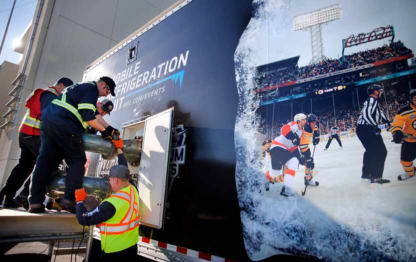 Workers assemble parts of the Mobile Refrigeration Unit which will freeze and keep the ice...