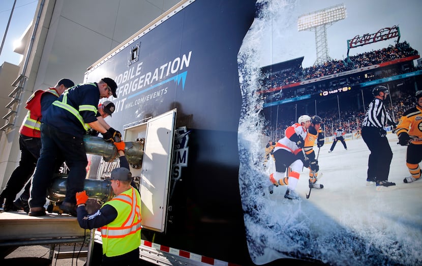 Workers assemble parts of the Mobile Refrigeration Unit which will freeze and keep the ice...