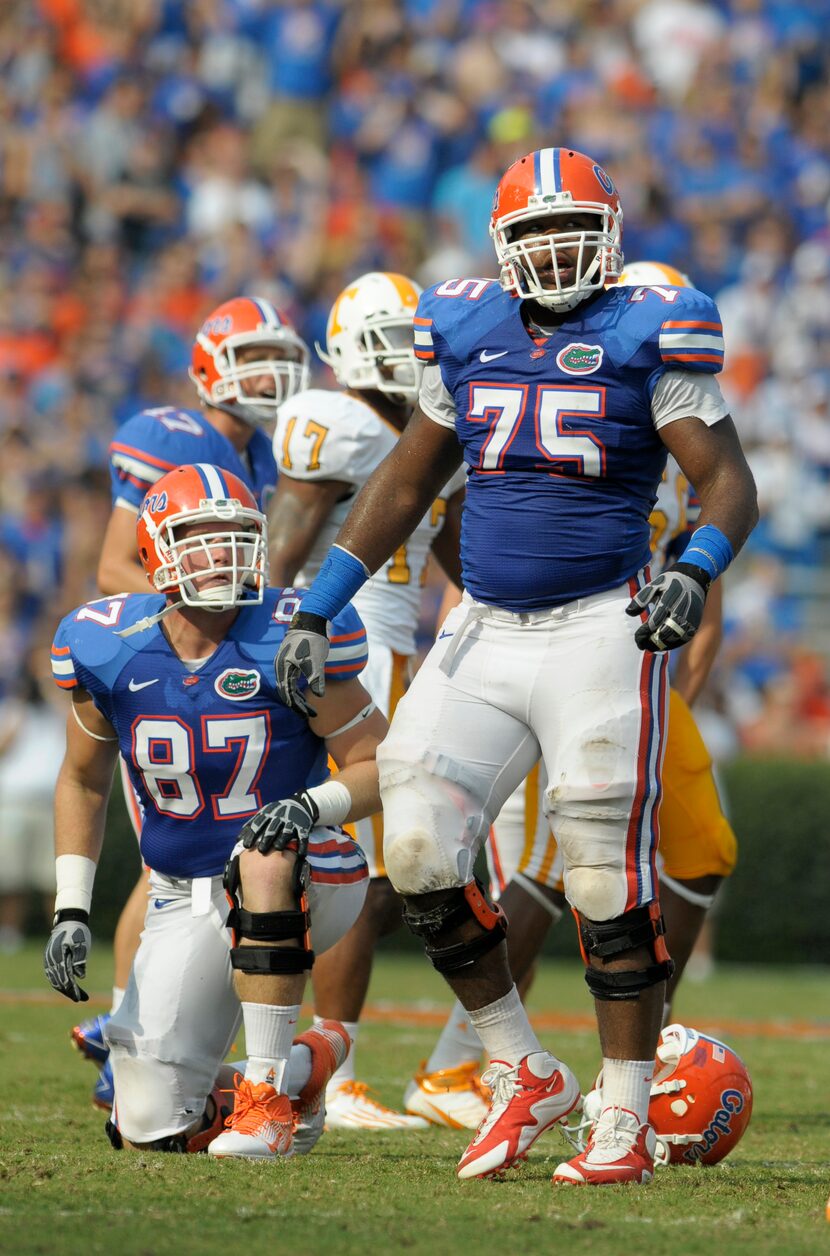 Florida tackle Chaz Green (75), right, and William Steinmann watch the results of a play...