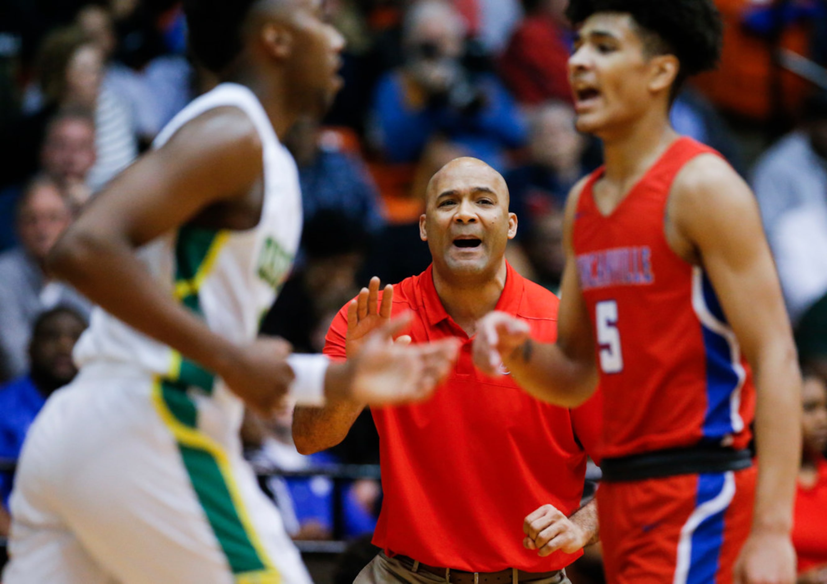 Duncanville head coach David Peavy shouts instructions to his son, junior guard Micah Peavy...