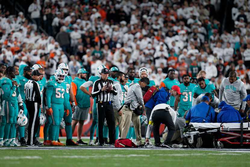 Miami Dolphins quarterback Tua Tagovailoa is attended to by medical staff after being sacked...