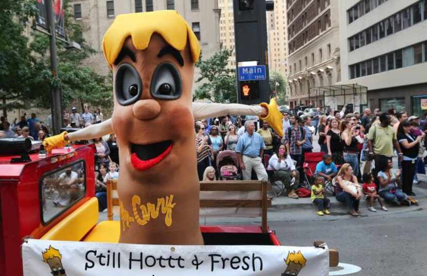 
A ginat Fletcher's Corny Dog waves to the crowd along the parade route during the State...