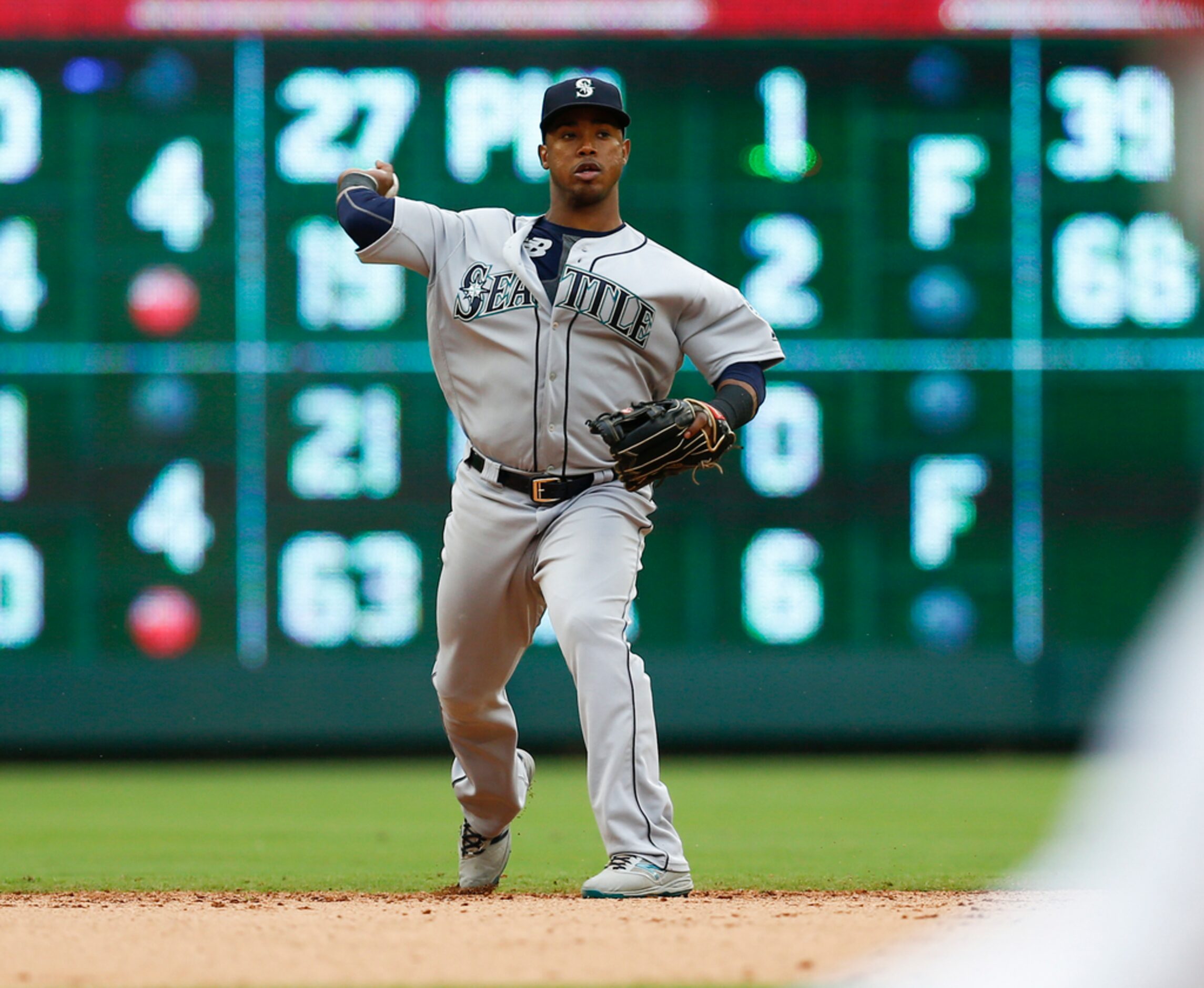 Seattle Mariners shortstop Jean Segura throws to first base on a ground-out hit by Texas...