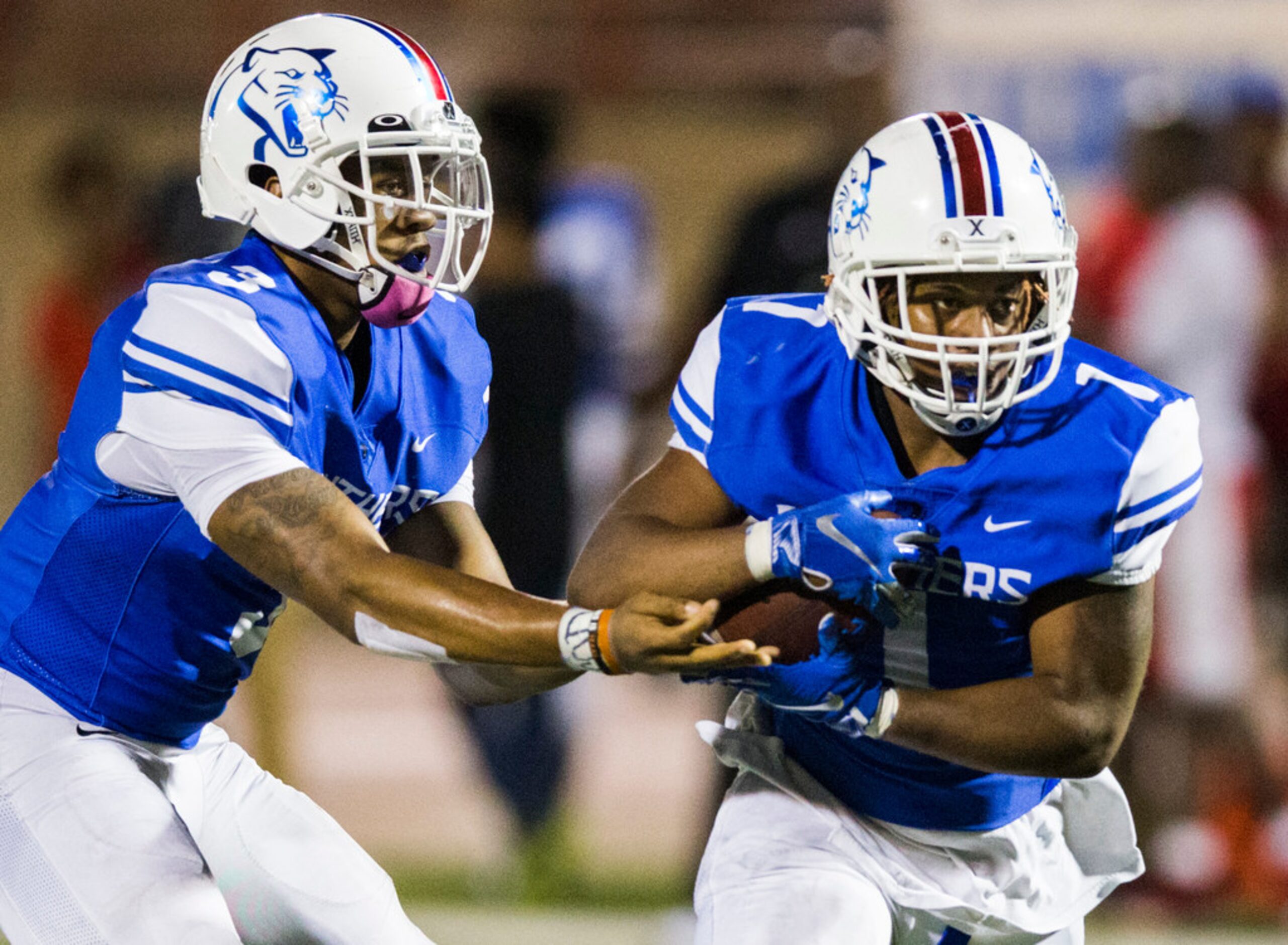 Duncanville quarterback Ja'Quinden Jackson (3) hands off the ball to running back Trysten...