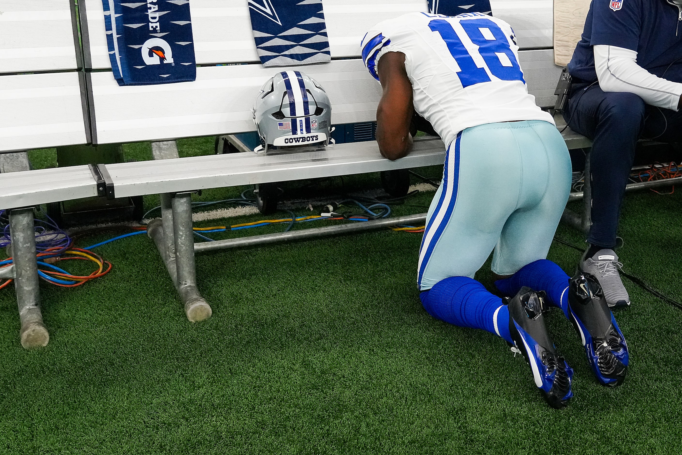 Dallas Cowboys linebacker Damone Clark prays on the bench before an NFL football game...