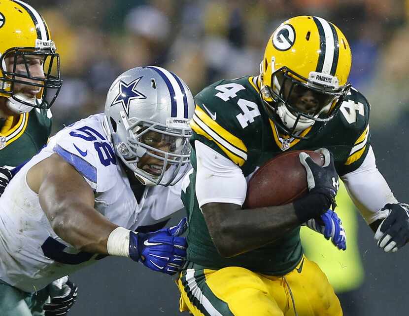 Dallas Cowboys defensive end Jack Crawford (58) reaches for Green Bay Packers running back...