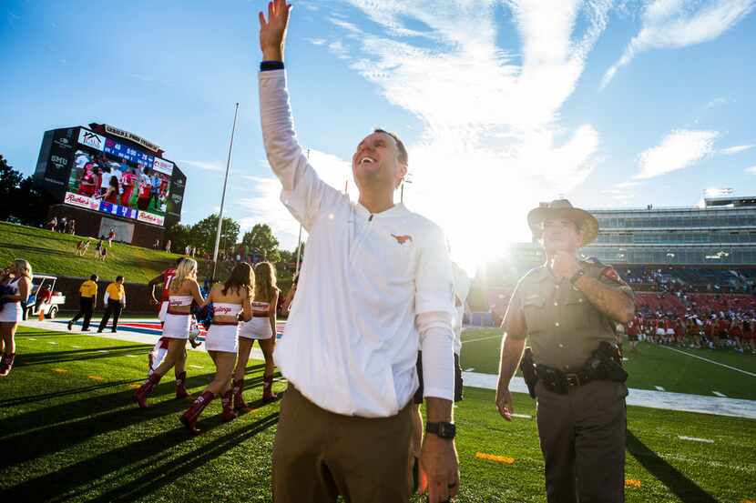 Southern Methodist Mustangs head coach Chad Morris waves to fans after a 49-28 win over the...