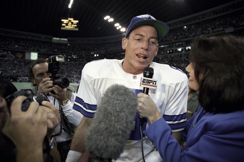 Dallas quarterback Troy Aikman #8 is interviewed by an ESPN sideline reporter after the...