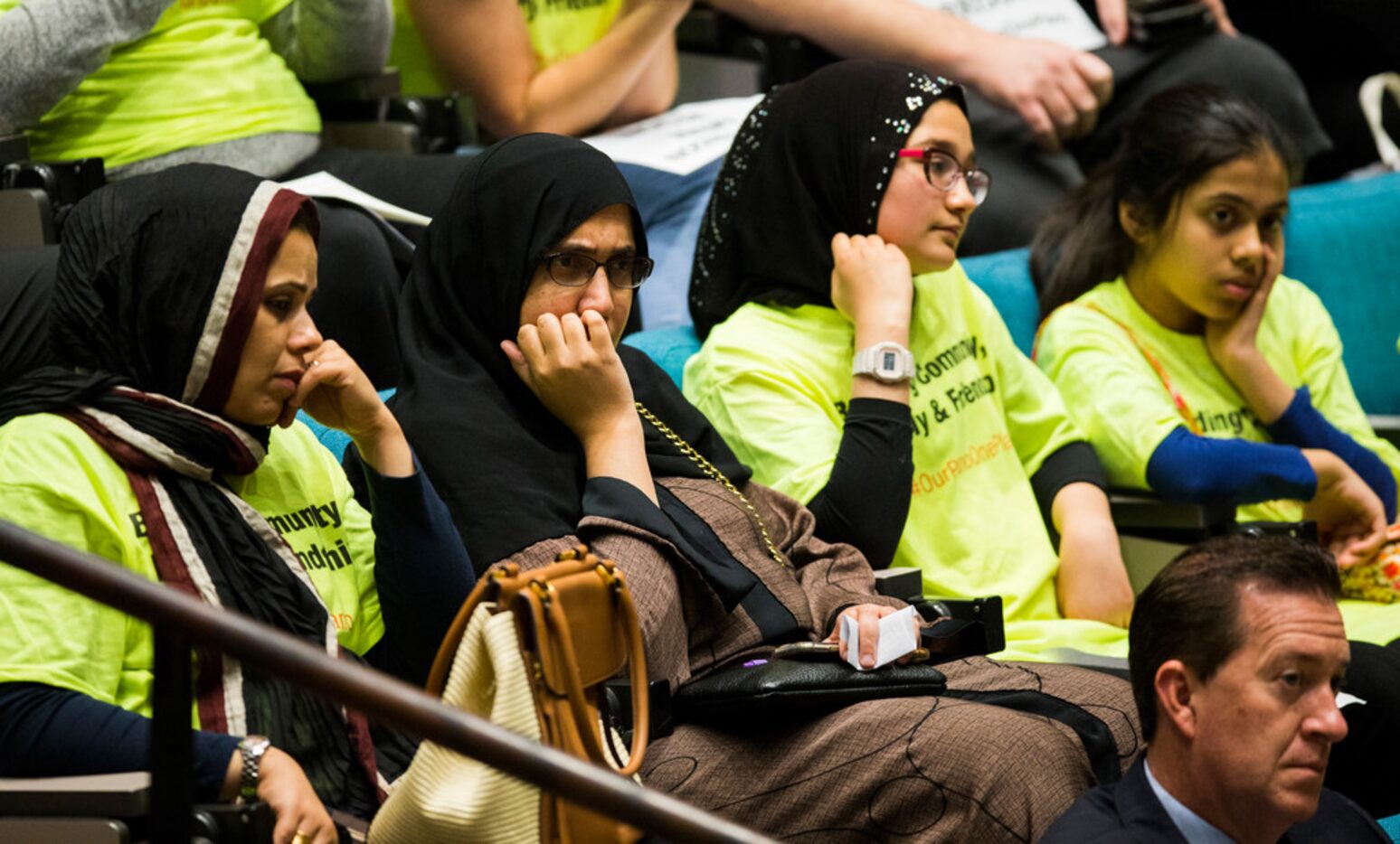 Plano citizens listen as Plano City Council member Tom Harrison defends his post on social...