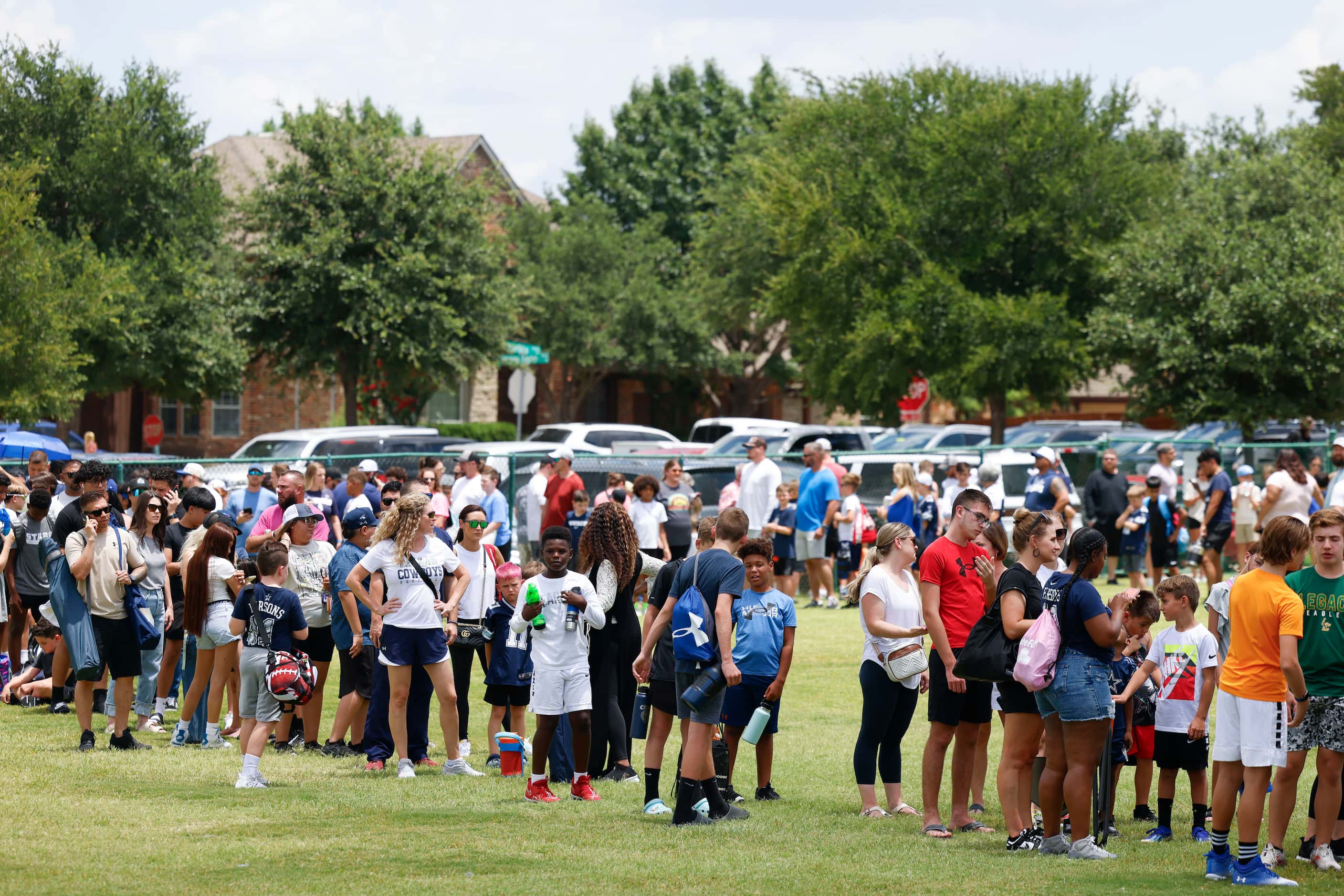 People stand in line to enter Dallas Cowboys linebacker Micah Parsons youth football camp,...