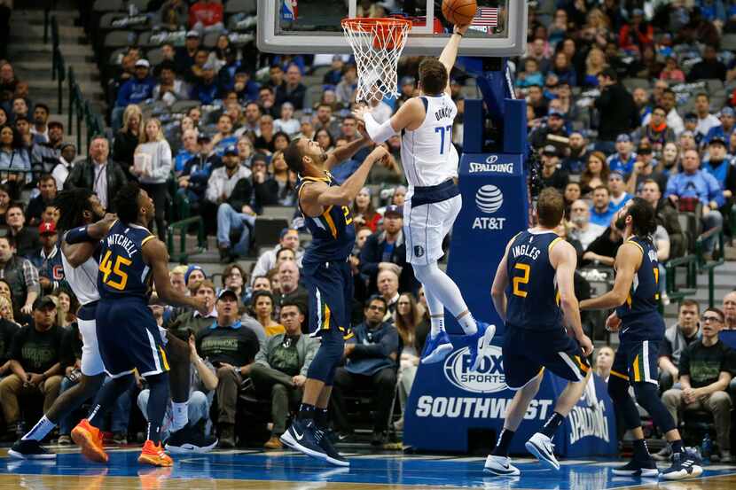 Dallas Mavericks forward Luka Doncic (77) lays the ball up in front of Utah Jazz center Rudy...