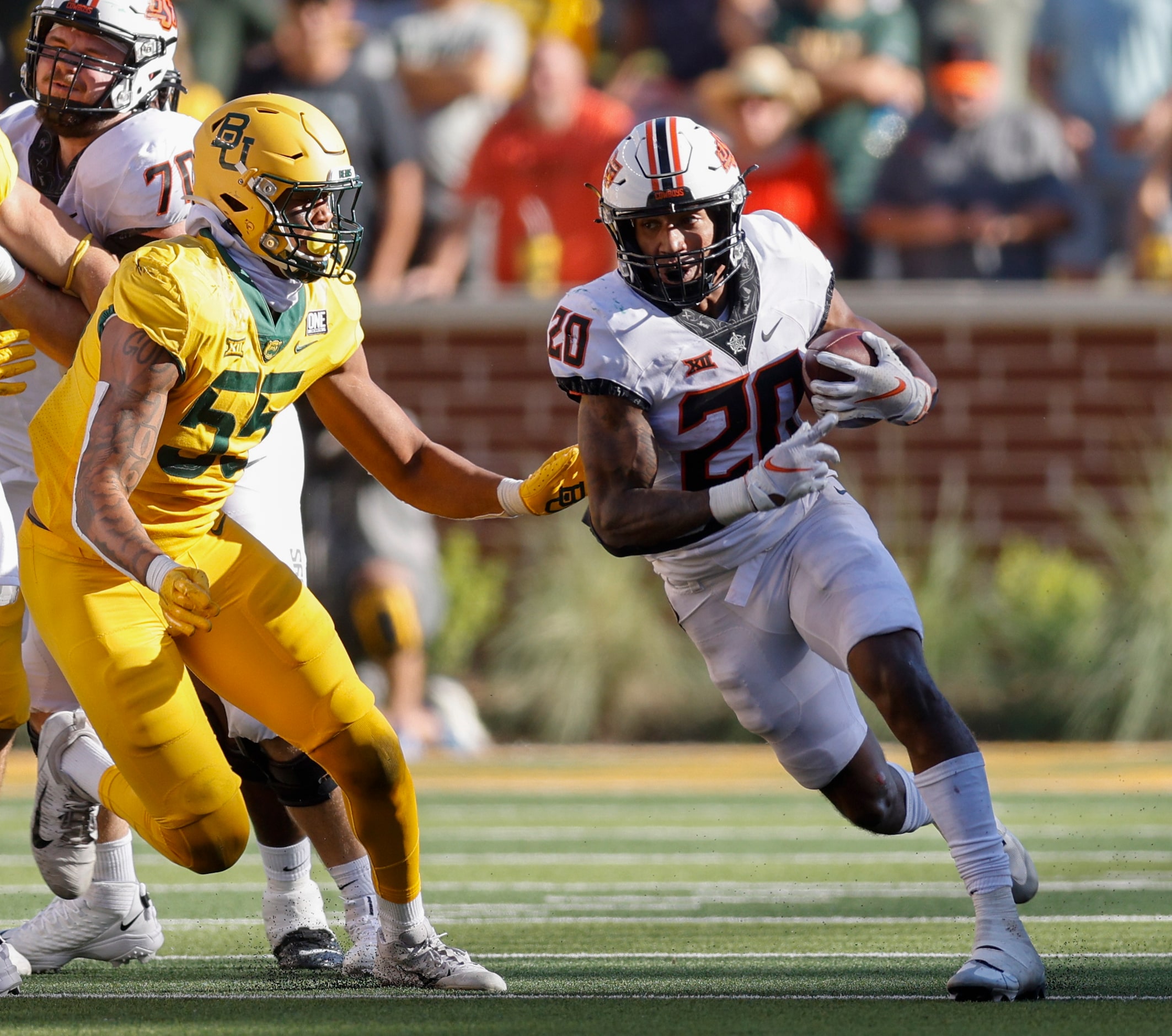 Oklahoma State running back Dominic Richardson (20) runs past Baylor linebacker Garmon...