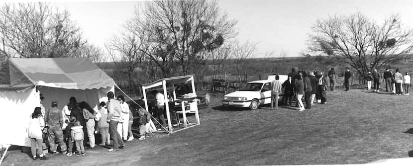 March 12, 1993: Vendors sell merchandise to onlookers in Waco. The tent on the left sold...