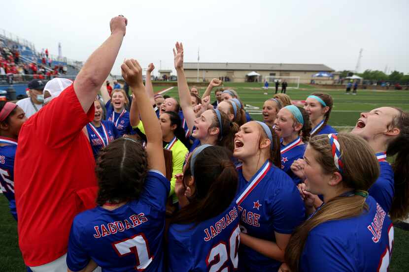 Midlothian Heritage head coach Gerald Slovacek cheers with his players at their win over...
