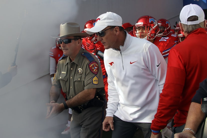 DALLAS, TX - NOVEMBER 26:  Head coach Chad Morris of the Southern Methodist Mustangs enters...